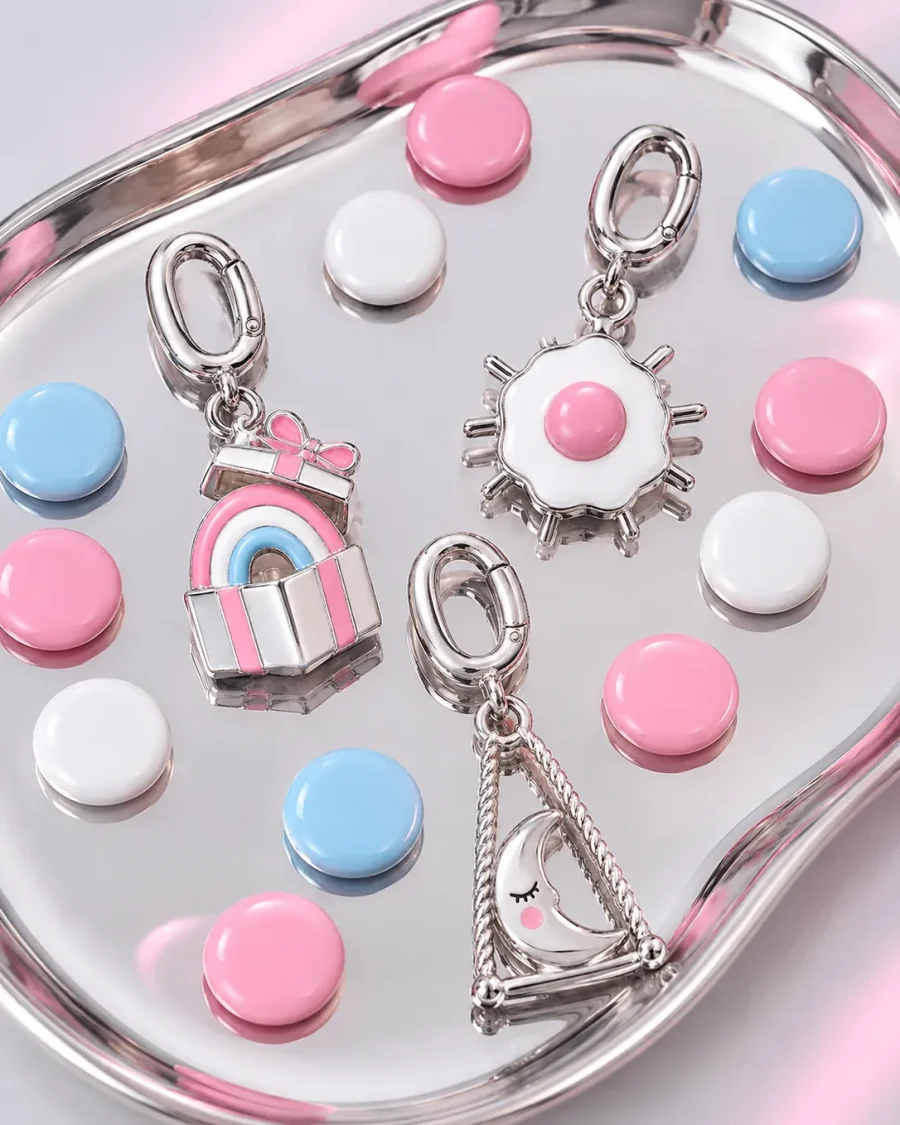 Enamel colour chips in candy pink, white and pale blue with three charms